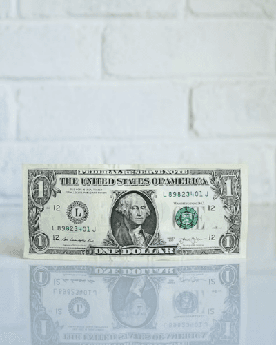 One dollar bill by the wall