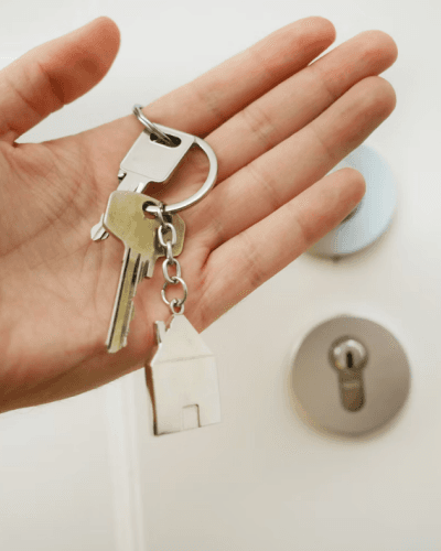 hand holding a key to a house