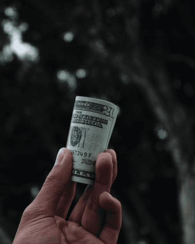 hand holding a roll of money